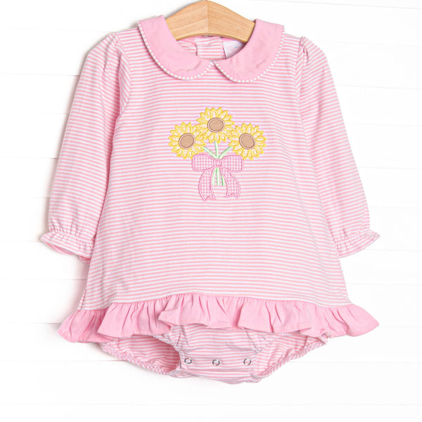 This skirted bubble features pink striped knit fabric, sunflower applique, a pink Peter Pan collar, and long sleeves.