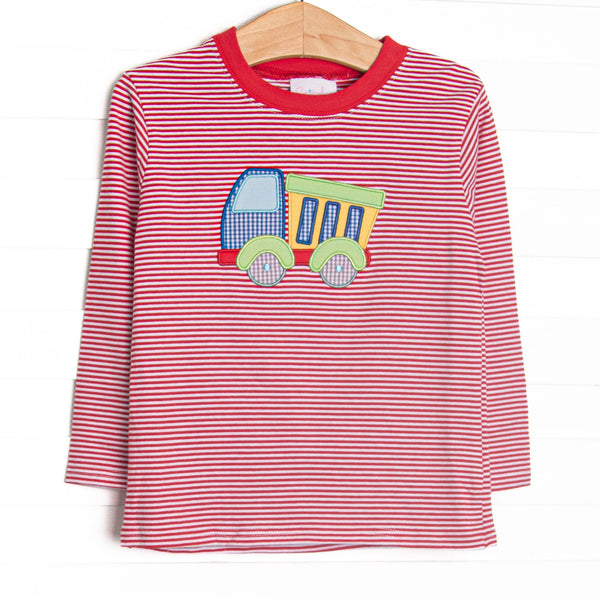  This top features a red striped print, long sleeves, and a dump truck applique. 