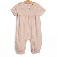 This romper features tan gingham fabric, a Peter Pan collar, and short sleeves.