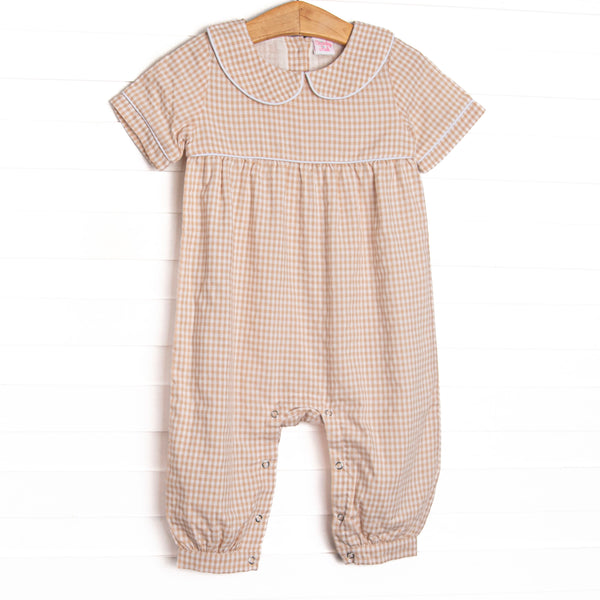 This romper features tan gingham fabric, a Peter Pan collar, and short sleeves.