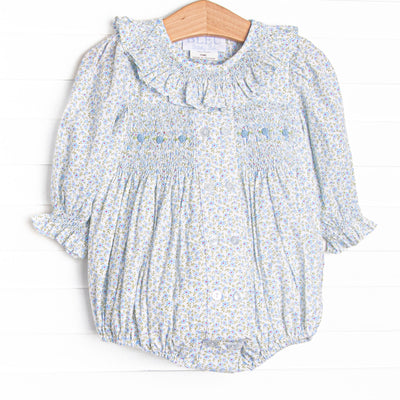 This bubble features a blue floral fabric, dainty smocking , and beautiful scalloped trimmed peter pan collar.