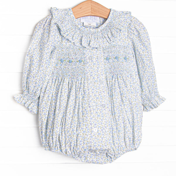 This bubble features a blue floral fabric, dainty smocking , and beautiful scalloped trimmed peter pan collar.