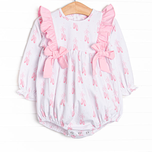  This bubble features a ballet slipper print, ruffle trim, and pink side ties. 