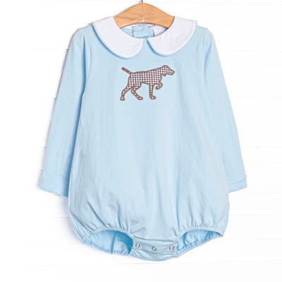 This bubble features a light blue knit material, a Peter Pan collar, and a puppy applique.