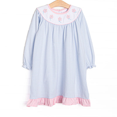 This dress features blue knit stripes, floral applique, and a white bib collar.