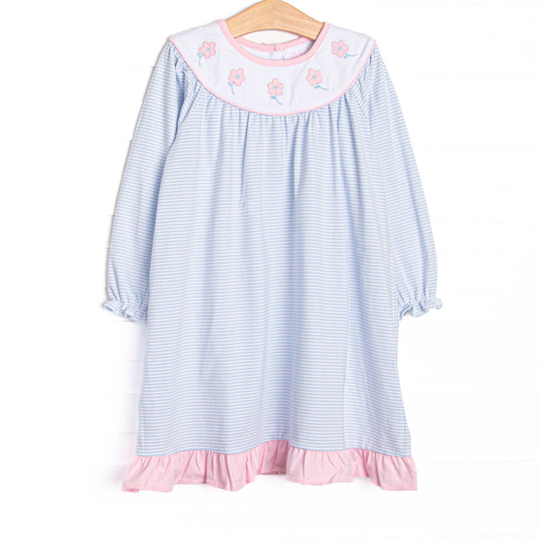 This dress features blue knit stripes, floral applique, and a white bib collar.