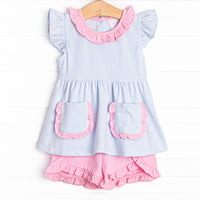 The set features a precious pink ruffle trim, sweet blue stripes, and breathable knit material