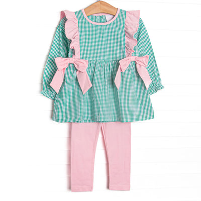 This set features green gingham fabric, pink flutter shoulders, and pink side ties. Coordinating pink leggings to match.