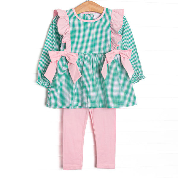This set features green gingham fabric, pink flutter shoulders, and pink side ties. Coordinating pink leggings to match.