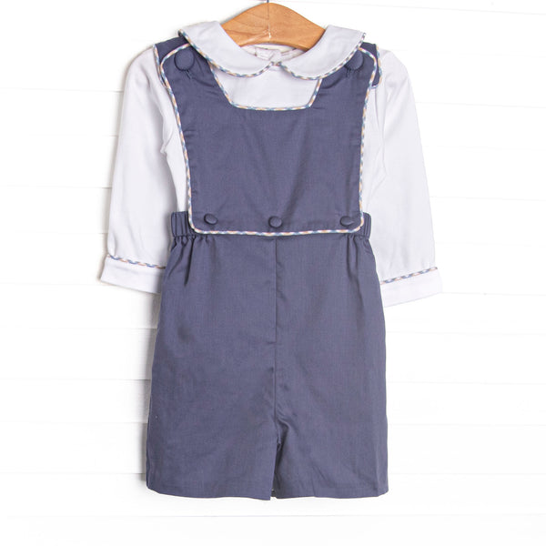 This set features a white top with a peter pan collar and a navy corduroy shortall with plaid piping.