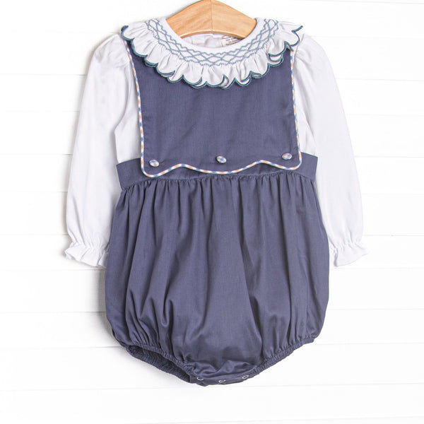 This bubble features a navy corduroy fabric, a button on bib, and white long sleeve top with a smocked scallop collar.