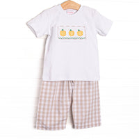 This set features a short sleeve top with a trio of pumpkin smocking and tan check pants to match.