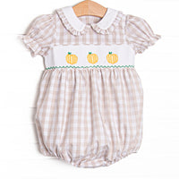 This bubble features a tan check print, a trio of pumpkin smockings, and puff sleeves.