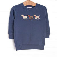 This sweatshirt features a navy blue knit material, long sleeves, and puppy appliques. 