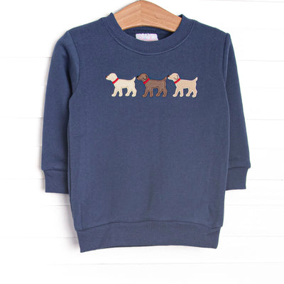 This sweatshirt features a navy blue knit material, long sleeves, and puppy appliques. 