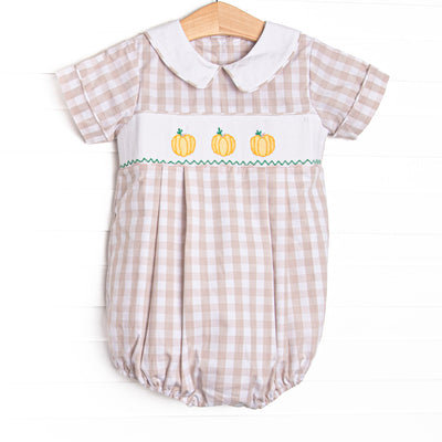 This bubble features a tan check print, a trio of pumpkin smocking, and a peter pan collar.