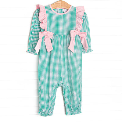 This romper features green gingham fabric, pink flutter shoulders, and pink side ties.