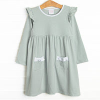 The dress features front ruffle pockets, white ruffle&nbsp; trim, and soft knit material.