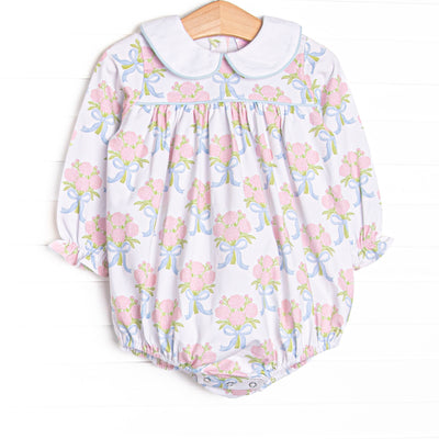 This bubble features white knit fabric, pink rose print, and a white Peter Pan collar.