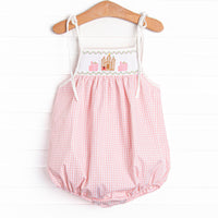  This bubble features a pink gingham print, shoulder ties, and castle smockings. 