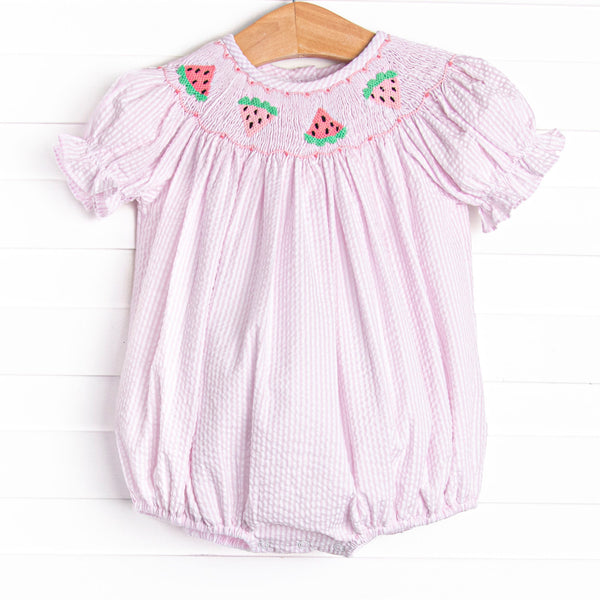 This bubble features a pink seersucker print, puff sleeves, and watermelon smockings.
