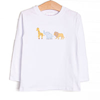 This top features white knit material, long sleeves, and an applique of giraffe, elephant, and lion.