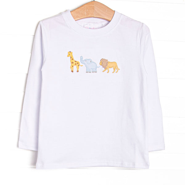 This top features white knit material, long sleeves, and an applique of giraffe, elephant, and lion.