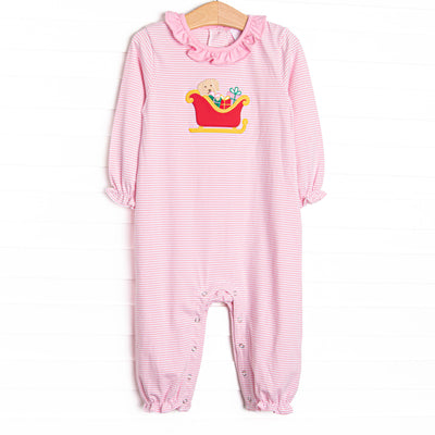 This romper features a pink striped print, snaps on the stride, and a puppy santa sleigh applique