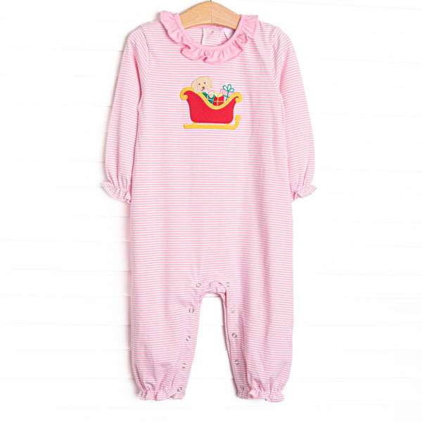This romper features a pink striped print, snaps on the stride, and a puppy santa sleigh applique