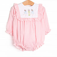  This bubble features a pink gingham print, ruffle trim, and a nutcracker embroidery. 