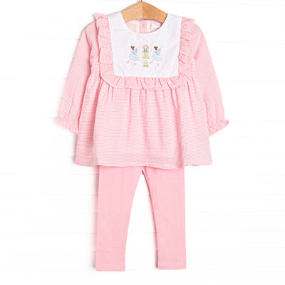 This set features a pink gingham print, ruffle trim, and a nutcracker embroidery. Coordinating pink leggings to match.