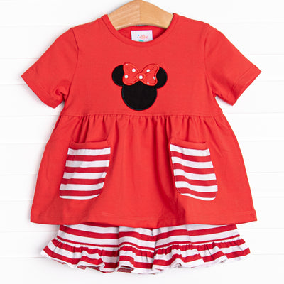  A bright pop of cheerful red, coupled with a red and white stripe ruffle shorts has us ready for a magical adventure. A mouse ears applique with a whimsical polka dot bow adorns the front of this set. 