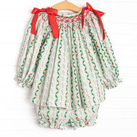 This set features a holly print, red bows, and a dainty smocking.