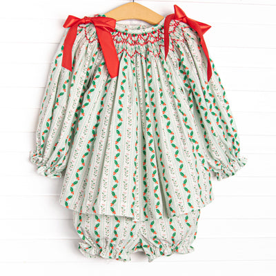 This set features a holly print, red bows, and a dainty smocking.