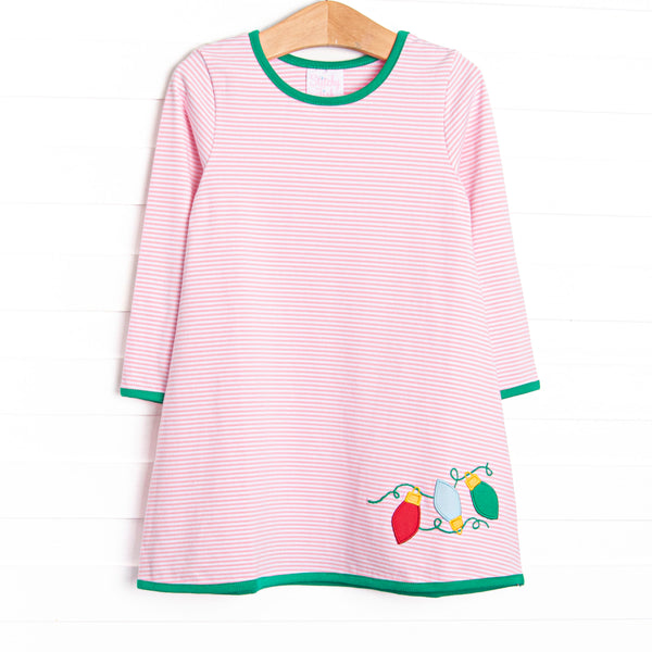 This dress features a pink striped print, green trim, and Christmas light appliques.