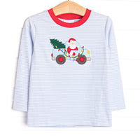  This top features a blue striped print, a red trim, and a santa truck applique. 