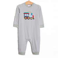 This romper features sage striped knit material, a steam engine applique, and snaps on the stride to make changing a breeze.