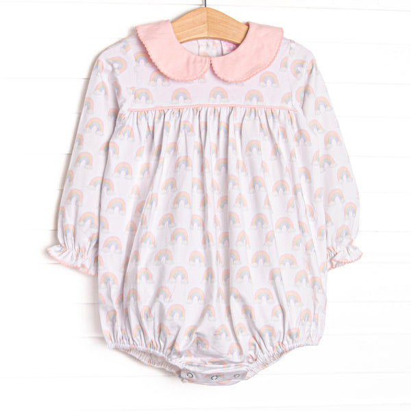 This bubble features rainbow patterned fabric, a pink Peter Pan collar, and long sleeves.