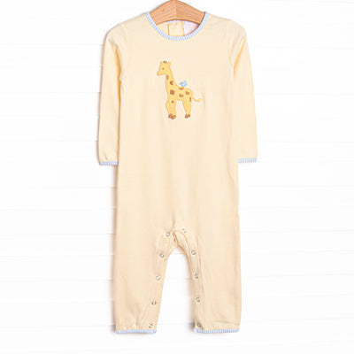  This romper features a yellow knit material, blue trim, and a giraffe applique. 