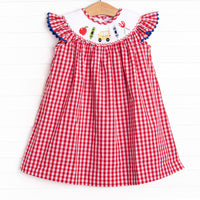  This dress features a red gingham print, flutter sleeves, and a back to school smocking. 
