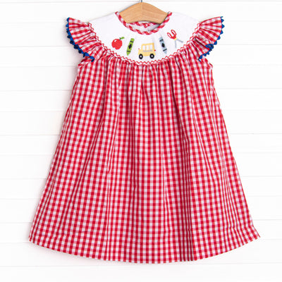  This dress features a red gingham print, flutter sleeves, and a back to school smocking. 