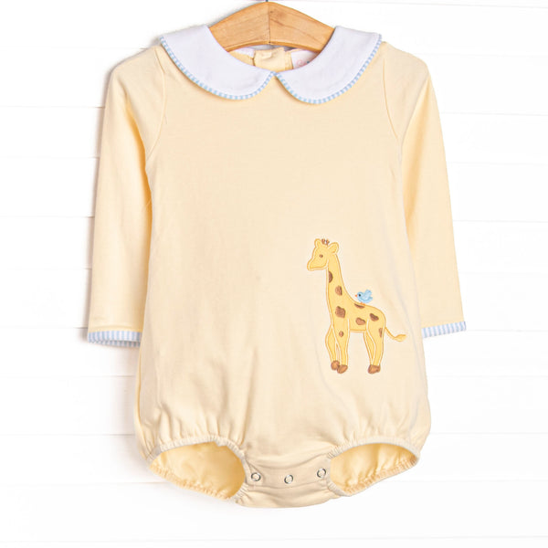 This bubble features a yellow knit material, a peter pan collar, and a giraffe applique.