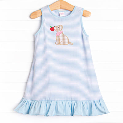  This dress features a blue striped print, blue ruffles, and a puppy applique. 