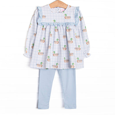 This set features a blue gingham duck print, ruffles around the chest, and long sleeves. Coordinating blue leggings to match.