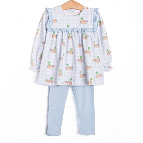 This set features a blue gingham duck print, ruffles around the chest, and long sleeves. Coordinating blue leggings to match.