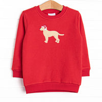 This sweatshirt features a red fleece material, a puppy applique and long sleeves. 