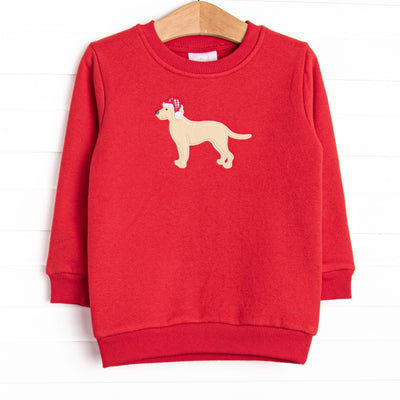 This sweatshirt features a red fleece material, a puppy applique and long sleeves. 