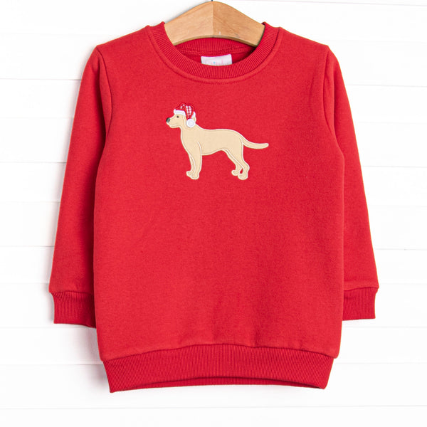 This sweatshirt features a red fleece material, a puppy applique and long sleeves. 