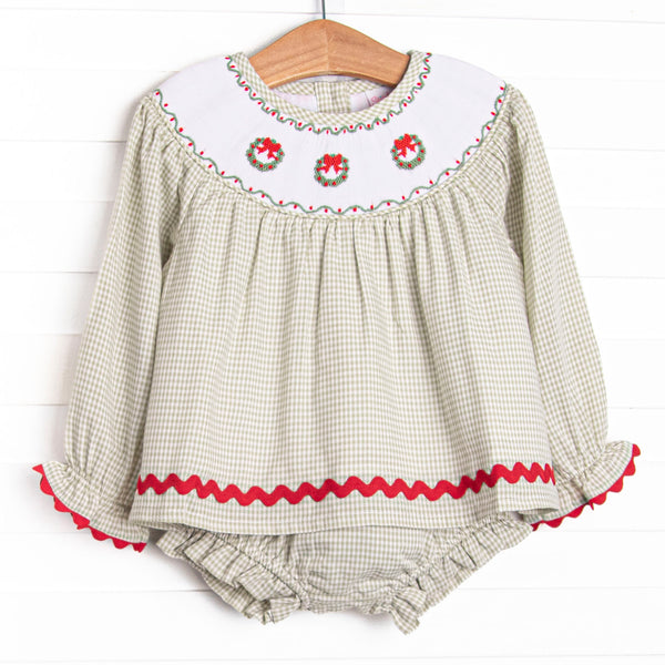 This set features a sage green gingham print, red ric rac trim, and a trio of wreath smockings.