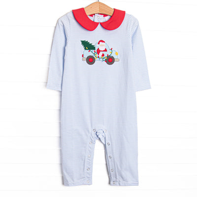 This romper features a blue striped print, a red peter pan collar, and a santa truck applique.
